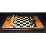 A BOXED VINTAGE CHESS BOARD, together with heavily varnised pieces. King height 7 cm.