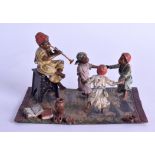 AN AUSTRIAN COLD PAINTED BRONZE FIGURAL GROUP depicting figures dancing and playing pipes upon a