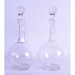 A PAIR OF ANTIQUE GLASS DECANTERS of fine quality with central monogram. 24.5 cm high.