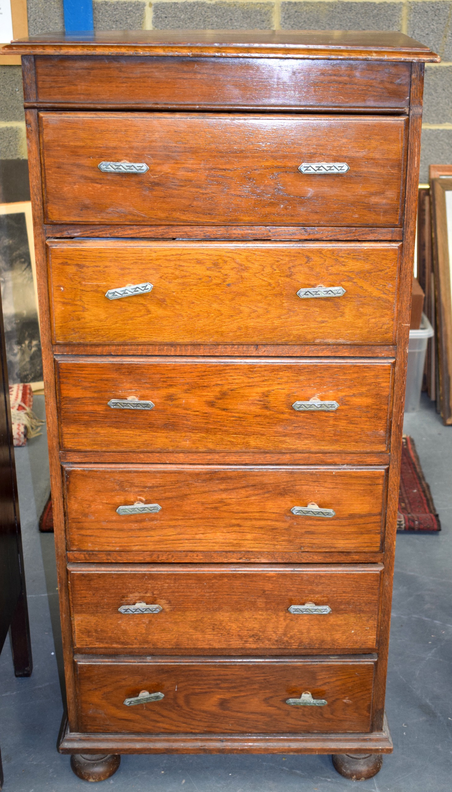 AN ANTIQUE CARVED OAK CHEST OF DRAWERS.130 cm x 61 cm.