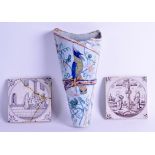 A PAIR OF 18TH CENTURY CONTINENTAL SQUARE FORM TILES painted with puce figures within landscapes,