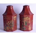 A PAIR OF CONTINENTAL LACQUERED AND PAINTED TIN CANISTER AND COVERS decorated with figures within