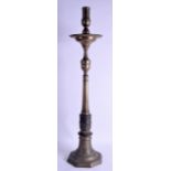 A LARGE 18TH CENTURY MIDDLE EASTERN BRASS CANDLESTICK with cylindrical column upon an octagonal