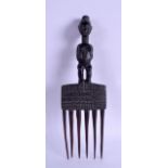 AN AFRICAN CARVED HARDWOOD COMB depicting a standing female. 29 cm long.