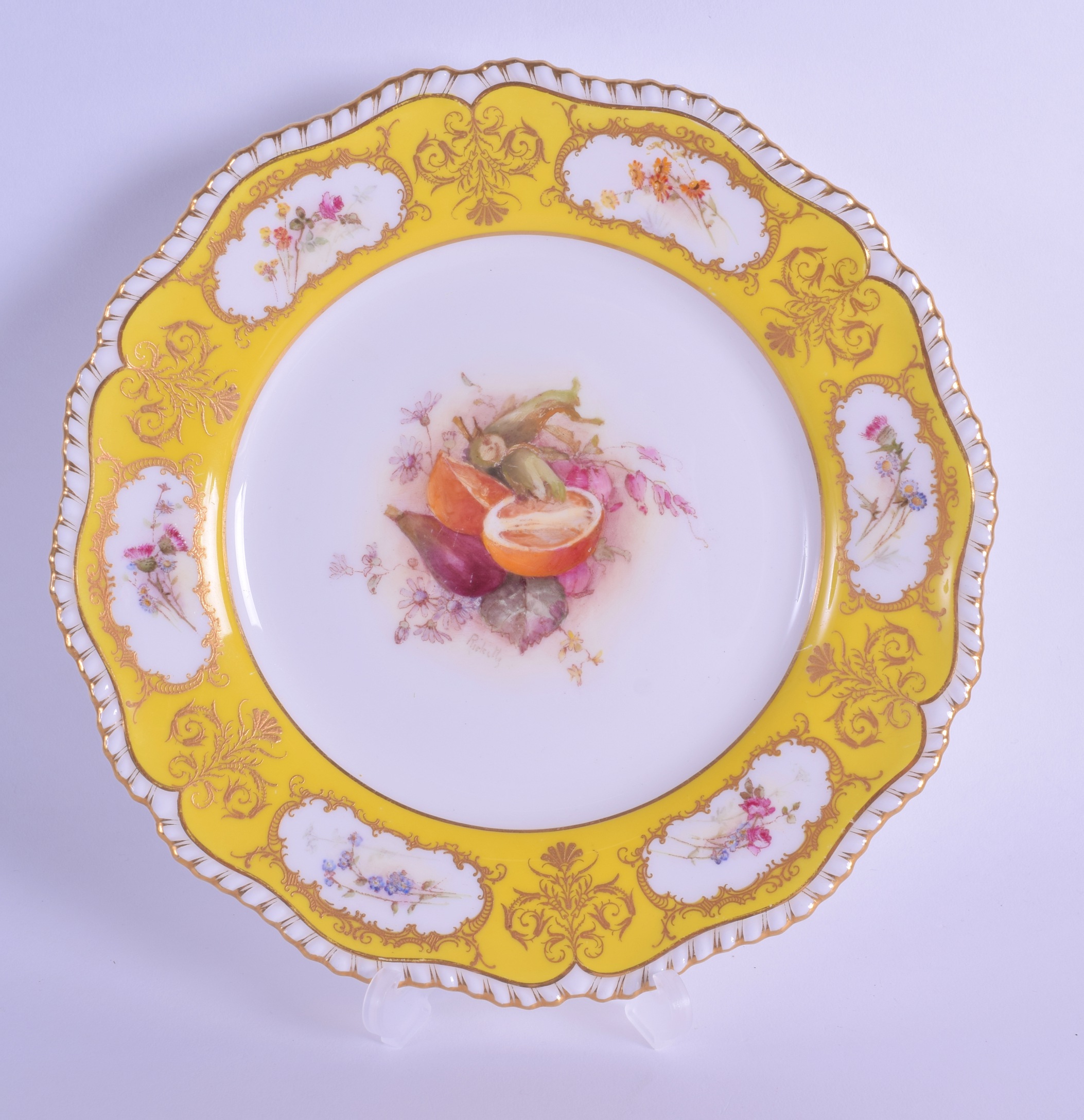 Royal Worcester fine plate painted with fruit including a cut orange, signed Ricketts under a yellow