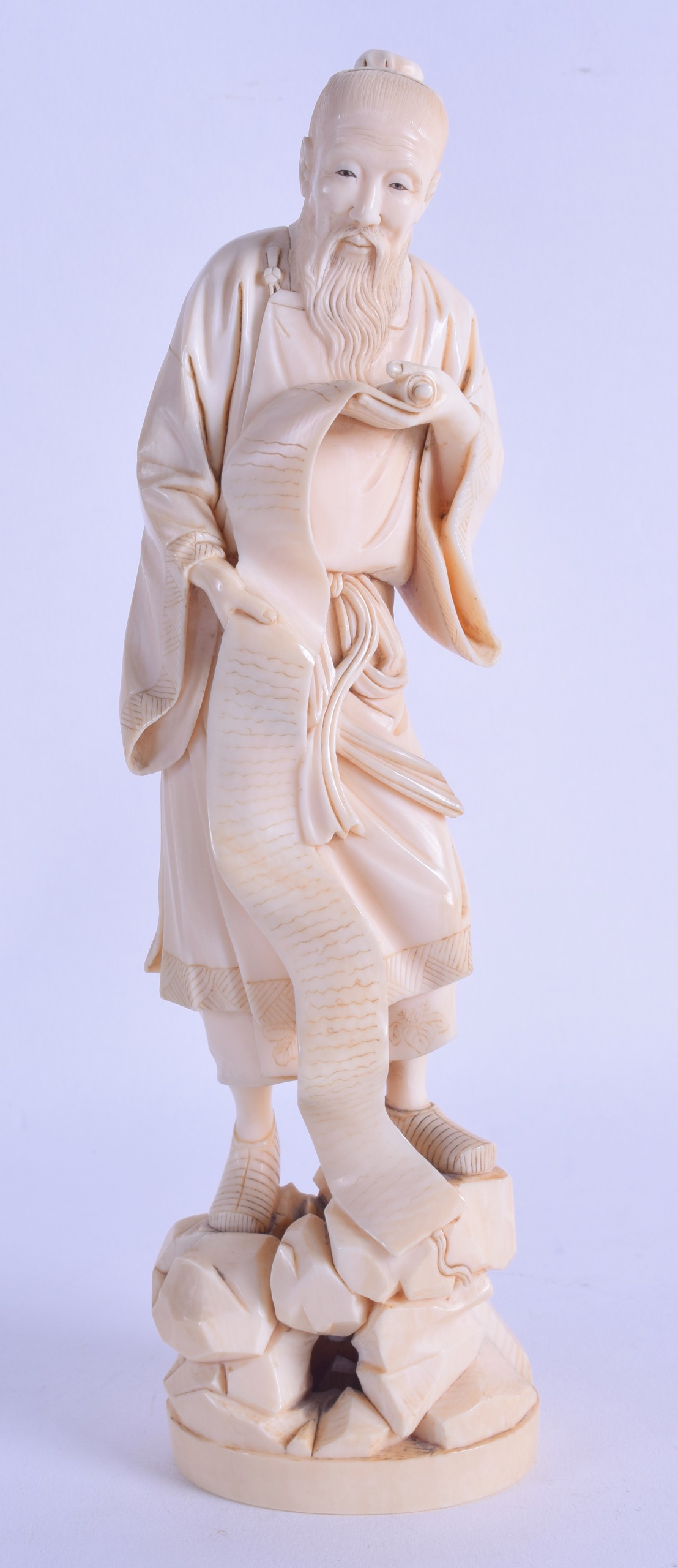 A GOOD 19TH CENTURY JAPANESE MEIJI PERIOD CARVED IVORY OKIMONO modelled as a male holding a scroll