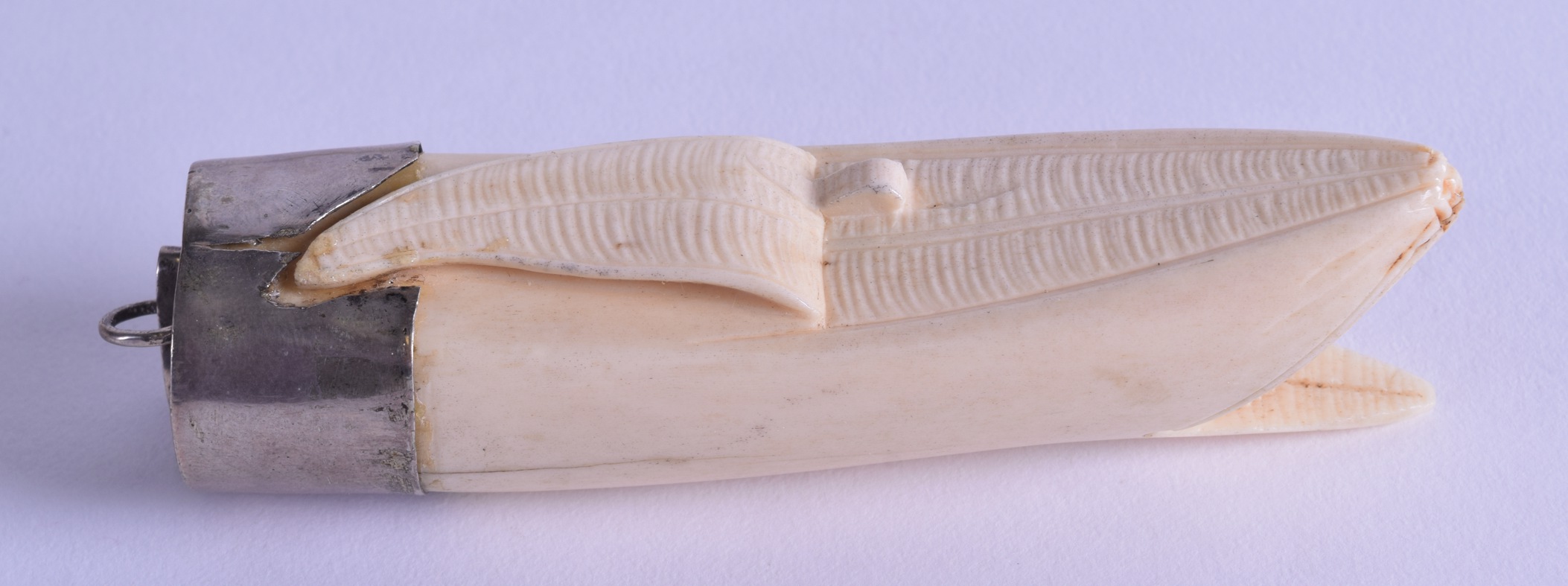 A 19TH CENTURY JAPANESE MEIJI PERIOD CARVED IVORY BANANA PENDANT with white metal mounts. 10.25 cm