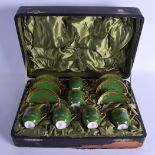 Coalport coffee set with raised gilding on a avocado green ground six demi-tasse cups and saucers,