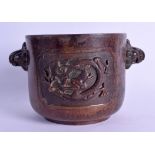 A CHINESE TWIN HANDLED BRONZE CENSER decorated in relief with a dragon. Overall 19 cm, Internal