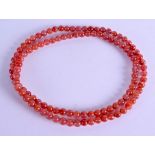 A CHINESE CARVED RED CARNELIAN AGATE NECKLACE. 82 cm long overall.