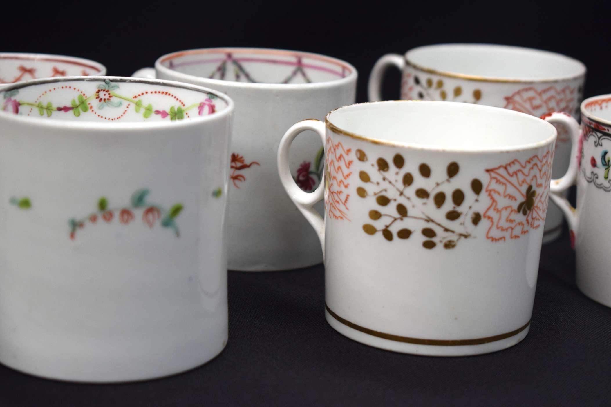 A GROUP OF NINE GOOD NEW HALL PORCELAIN COFFEE CUPS, of varying pattern. - Image 3 of 4