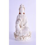 A CHINESE BLANC DE CHINE FIGURE OF GUANYIN modelled holding a vessel upon a lotus base. 27 cm high.