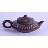 A CHINESE YIXING POTTERY TEAPOT AND COVER engraved with calligraphy. 15 cm wide.