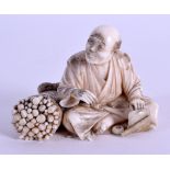 A 19TH CENTURY JAPANESE MEIJI PERIOD CARVED IVORY OKIMONO modelled as a male beside a stack of