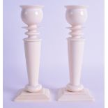 A GOOD PAIR OF 19TH CENTURY EUROPEAN CARVED IVORY CANDLESTICKS of classical form upon rectangular