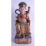 A 19TH CENTURY CHINESE CARVED AND POLYCHROMED WOODEN FIGURE OF A MALE modelled upon a throne. 41
