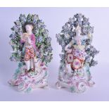 18th c. Derby pair of figures of a boy piping and a girl dancing before a brocage. 23cm High