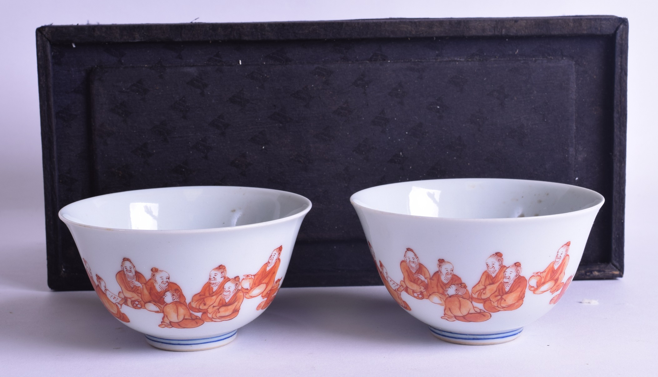 AN UNUSUAL PAIR OF EARLY 20TH CENTURY CHINESE IRON RED BOWLS painted with figures seated within - Image 2 of 3