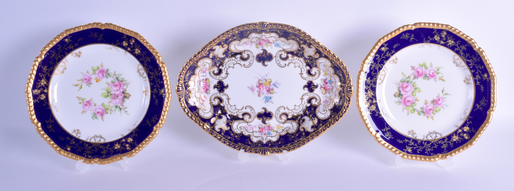 Royal Crown |Derby shaped oval shaped dish painted with flowers in blue and gilt reserves and a pair