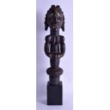 AN AFRICAN CARVED HARDWOOD FERTILITY FIGURE depicting a powerful female with mirrored eyes. Figure