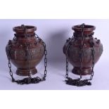 A PAIR OF 19TH CENTURY CHINESE BRONZE HANGING VASES decorated with archaic motifs. Vase 21 cm high.