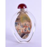 A CHINESE REVERSE PAINTED GLASS SNUFF BOTTLE painted with figures within landscapes. 9.5 cm high.