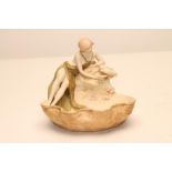 AN ART NOUVEAU ROYAL DUX BISQUE PORCELAIN FIGURAL SMALL CENTREPIECE modelled as a young scantily