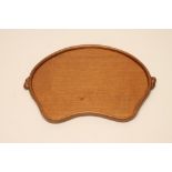 A ROBERT THOMPSON ADZED OAK TRAY of kidney form with two carved mouse trademark lug handles, 18"