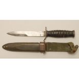 A US M8 FIGHTING KNIFE, with 6 3/4" spear point blade stamped U.S. M3 PAL, leather sectional grip,