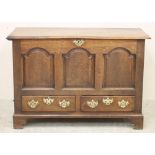 A GEORGIAN OAK PANELLED CHEST, late 18th century, the moulded edged plank lid opening to interior