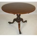 A GEORGIAN MAHOGANY TRIPOD TABLE, c.1800, the circular tip up top on baluster turned stem, the