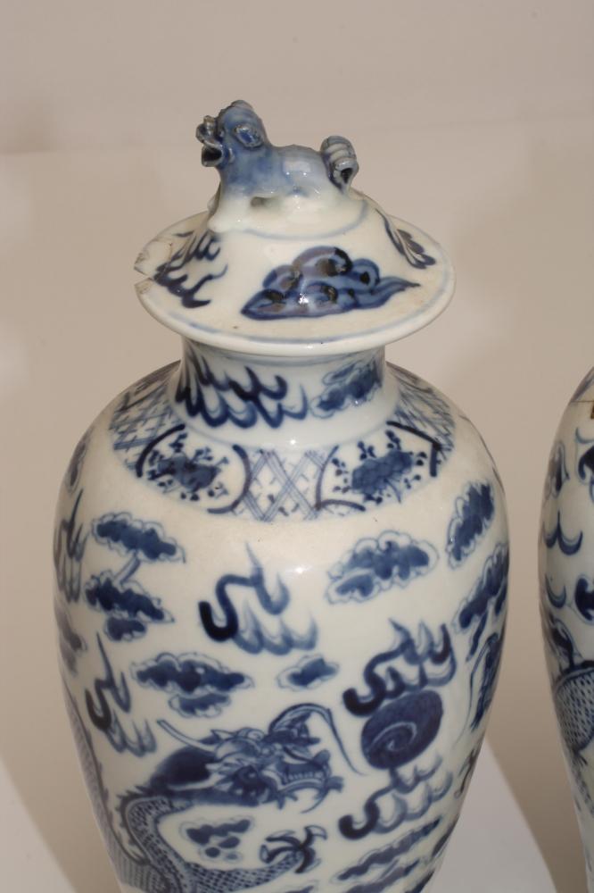 A PAIR OF CHINESE PORCELAIN VASES AND COVERS, of inverted baluster form, painted in underglaze - Image 3 of 5