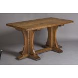 A ROBERT THOMPSON ADZED OAK REFECTORY TABLE, the rounded oblong three plank top with incised