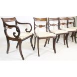 A SET OF FIVE REGENCY MAHOGANY DINING CHAIRS including an elbow chair, the scroll back uprights with