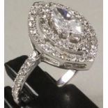 A DIAMOND CLUSTER RING, the central marquise cut stone of 0.71cts, claw set to a double open