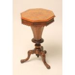 A VICTORIAN WALNUT SEWING TABLE of octagonal form, the moulded edged burr veneered lid opening to