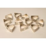 A SET OF TWELVE ART DECO SILVER NAPKIN RINGS, makers Gloster, Sheffield 1927, of triangular form