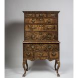 AN EARLY GEORGIAN WALNUT CHEST ON STAND, with moulded cornice, three small top drawers with
