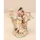 A DERBY PORCELAIN FIGURAL TWO BRANCH CANDELABRUM, c.1770, modelled as young piping shepherd