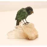 A JADEITE PARROT, modern, naturalistically carved and stained with glass eyes and cast metal legs,
