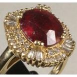 A RUBY AND DIAMOND CLUSTER RING, the oval facet cut ruby claw set to a border pave set with numerous