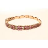 AN ART DECO RUBY AND DIAMOND BRACELET, claw set with twenty four graduated pairs of round facet