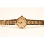 A LADY'S 9CT GOLD OMEGA WRISTWATCH, the matt gilt circular dial with applied gilt metal line batons,