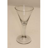 A LARGE TRUMPET WINE GLASS, the flared bowl issuing from a cylindrical stem enclosing a single tear,