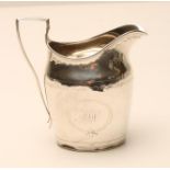 A LATE GEORGE III SILVER MILK JUG, makers probably Smith & Hayter, London 1801, of bombe oval form