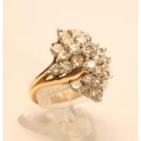 A DIAMOND ABSTRACT CLUSTER RING, the twenty seven brilliant cut stones totalling approximately 2.