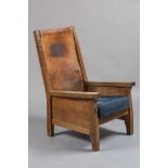 A ROBERT THOMPSON ADZED OAK SMOKING CHAIR, the square tapering uprights enclosing a cow hide back,