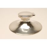 AN ART DECO SILVER CAPSTAN INKWELL, makers A & J Zimmerman, Birmingham 1933, of typical form with