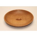 A ROBERT THOMPSON ADZED OAK BOWL, of plain shallow circular form with central carved mouse trademark