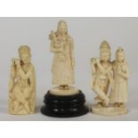 THREE INDIAN IVORY FIGURES, c.1880's, carved as Hindu deities, two fixed to circular bases and one